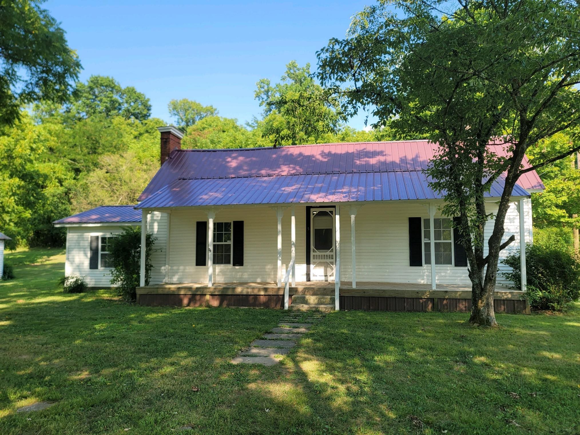 a view of a house with a yard porch and sitting area