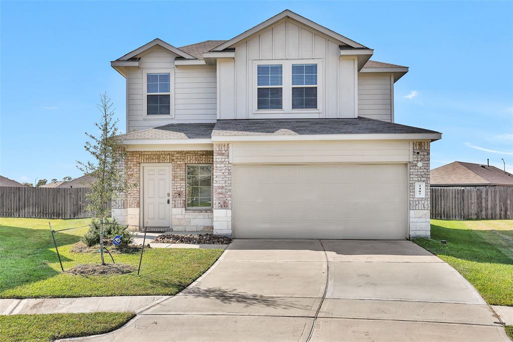 a front view of a house with a yard and garage