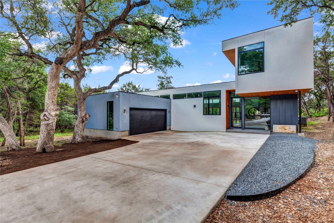 a view of a house with a tree and a yard