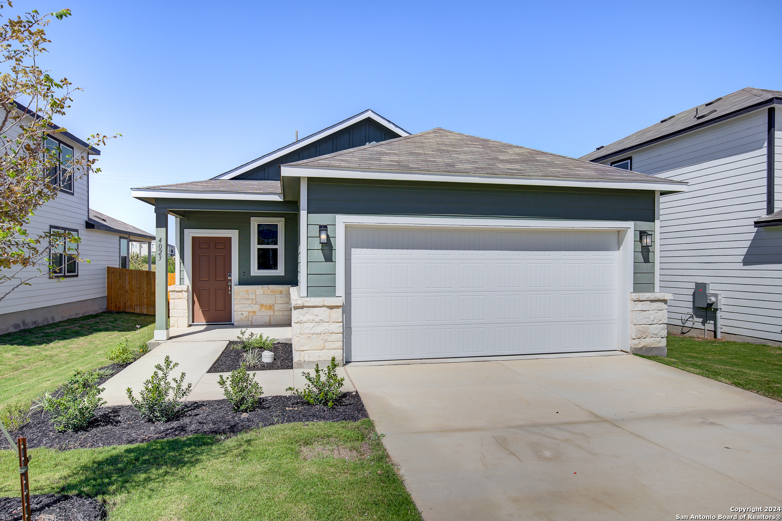 a front view of a house with garden