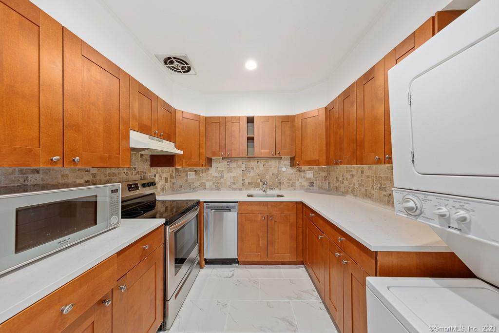 a kitchen with stainless steel appliances granite countertop a sink and cabinets