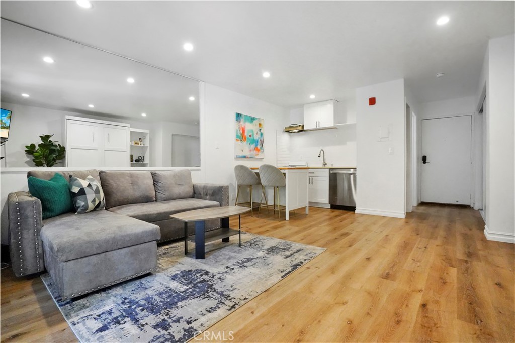 a living room with furniture and kitchen view