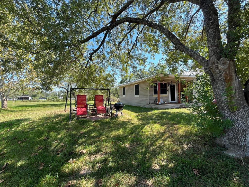 a view of a house with a backyard