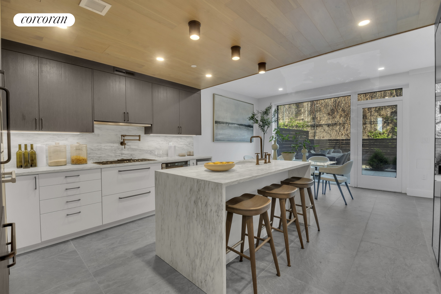 a kitchen with a table chairs sink and cabinets