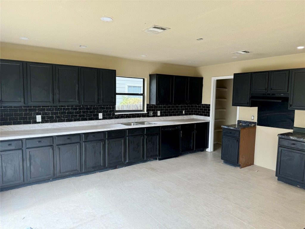 a kitchen with stainless steel appliances granite countertop a stove a sink dishwasher a refrigerator and a microwave