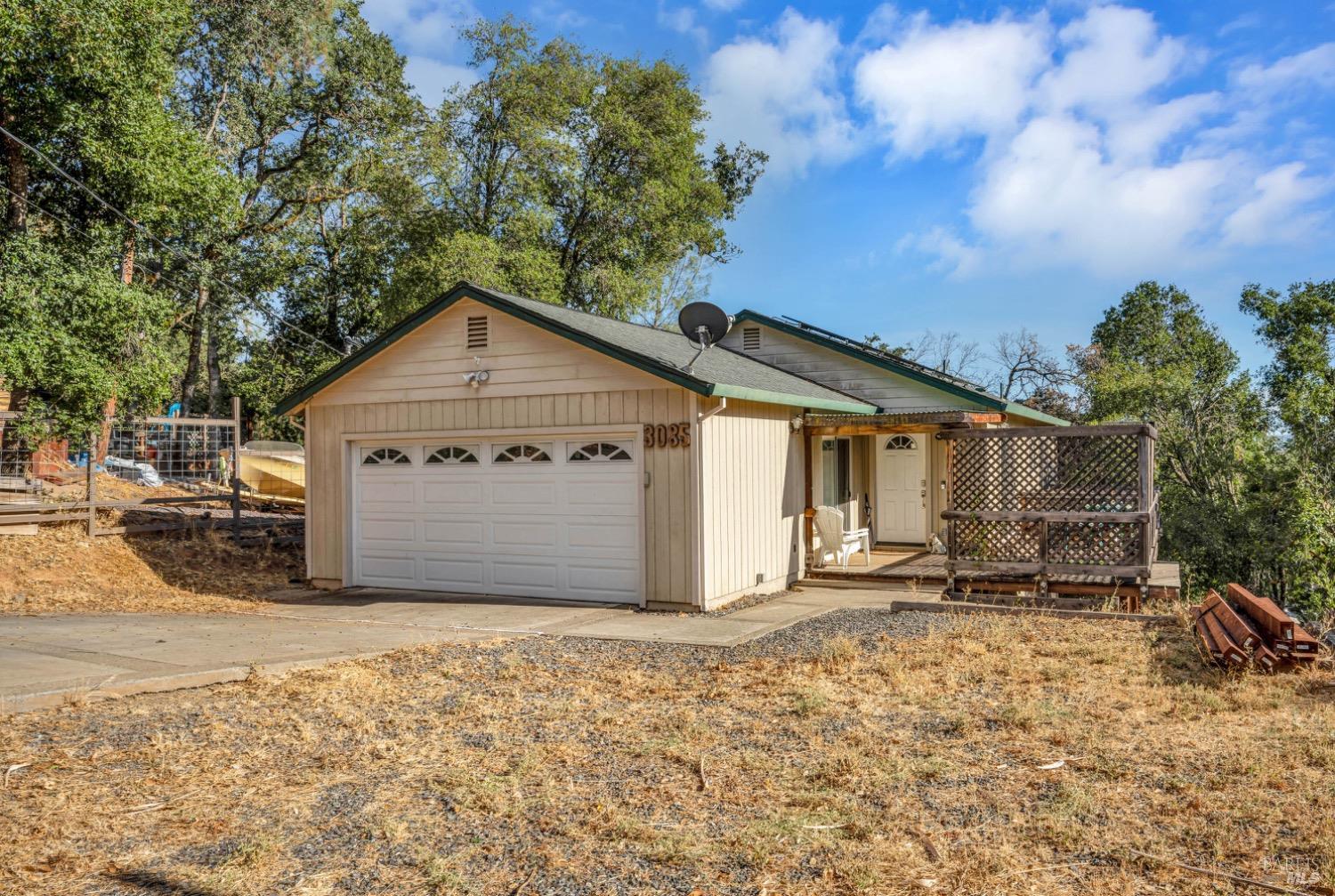 Two car garage with lots of level parking area.