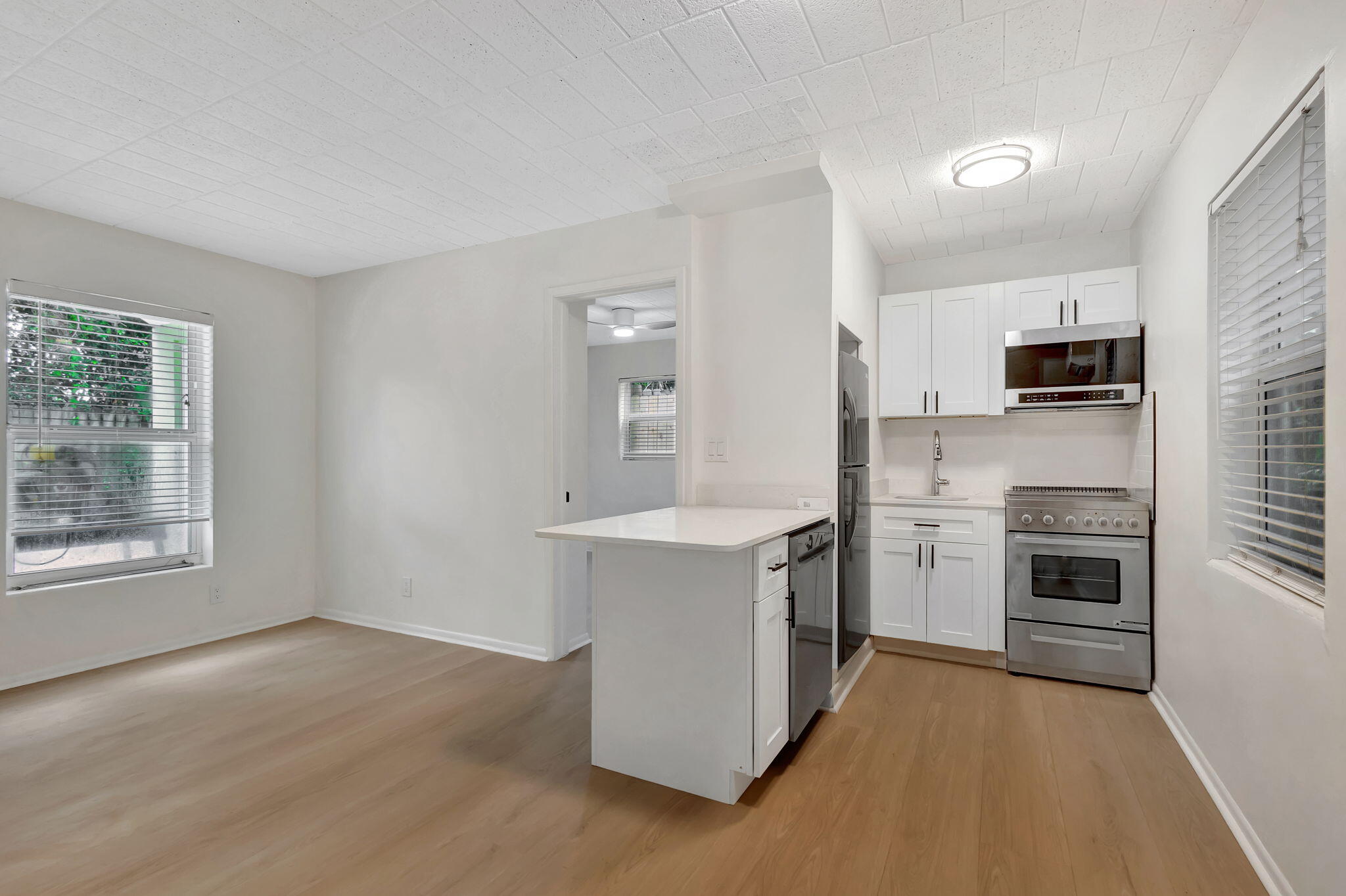 a kitchen with a refrigerator stove and oven