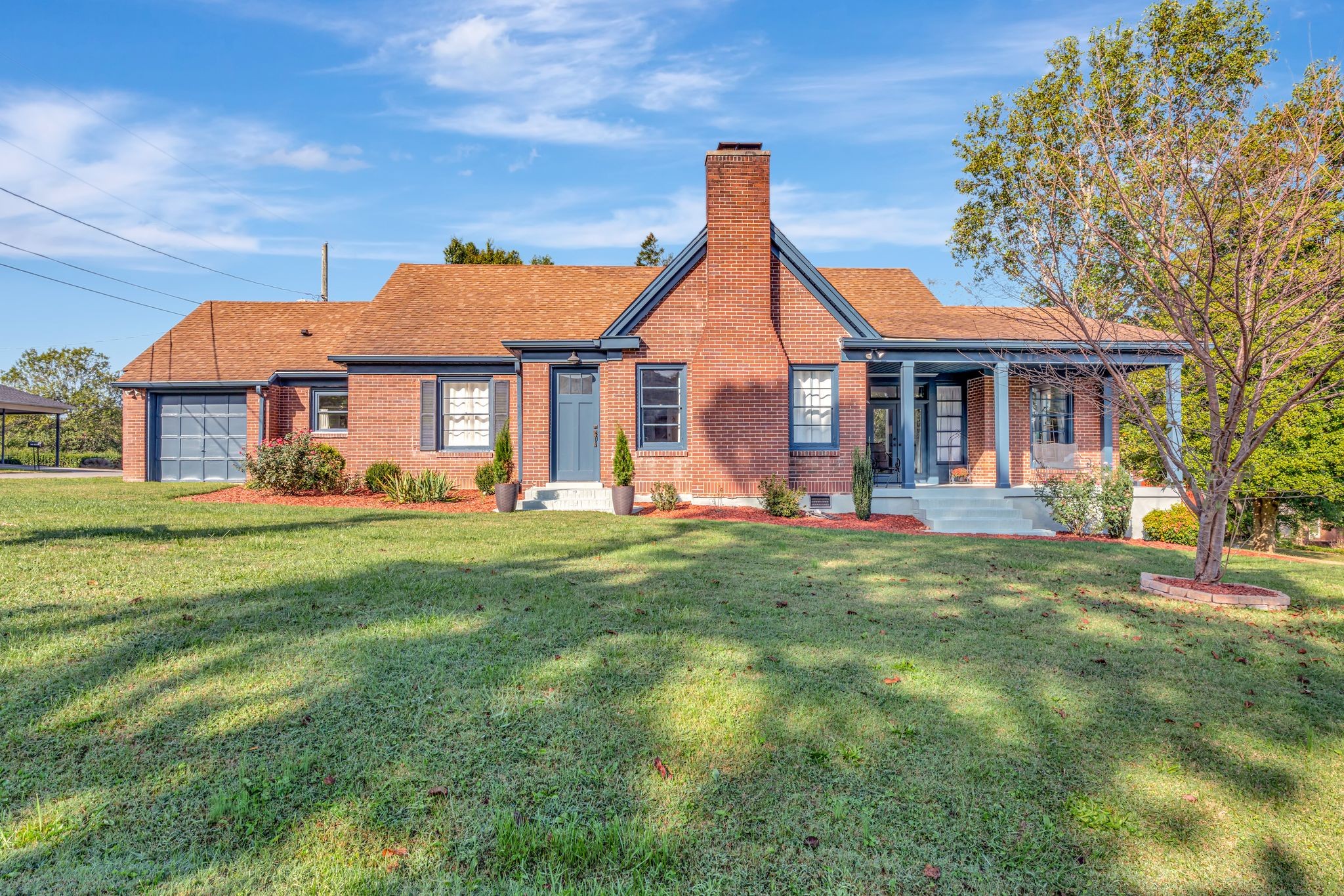 a front view of a house with a garden and porch