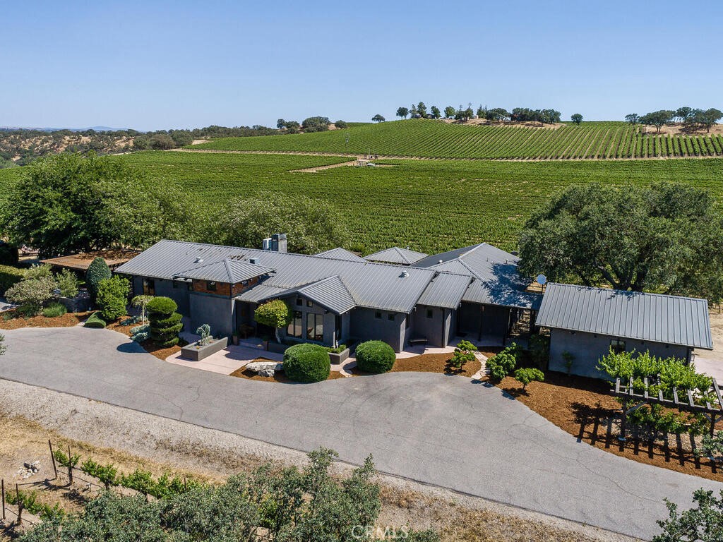 an aerial view of a house with garden space and street view