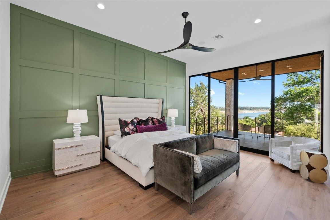 a bedroom with a bed and large window