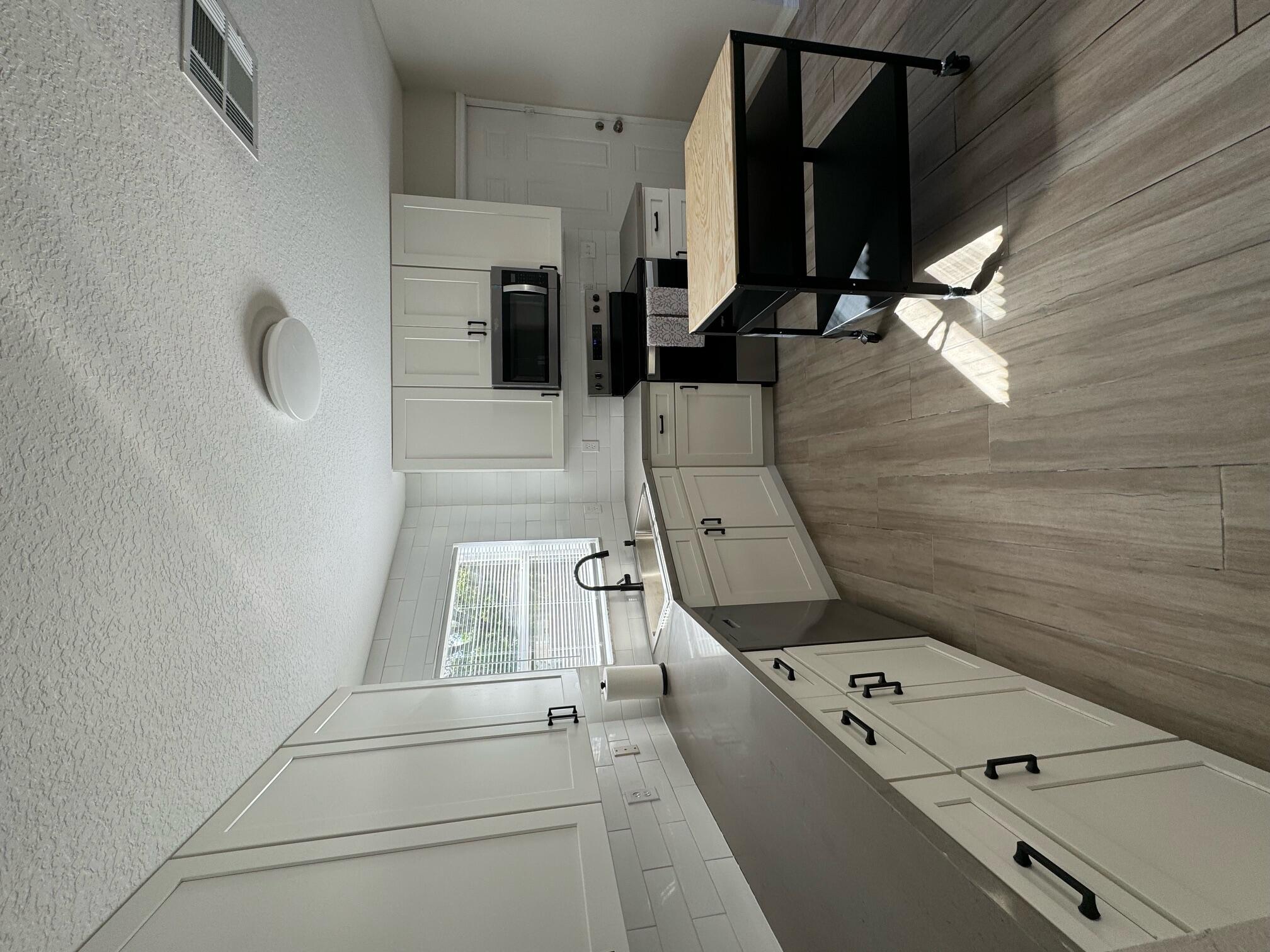 a kitchen with a sink appliances and a counter top space