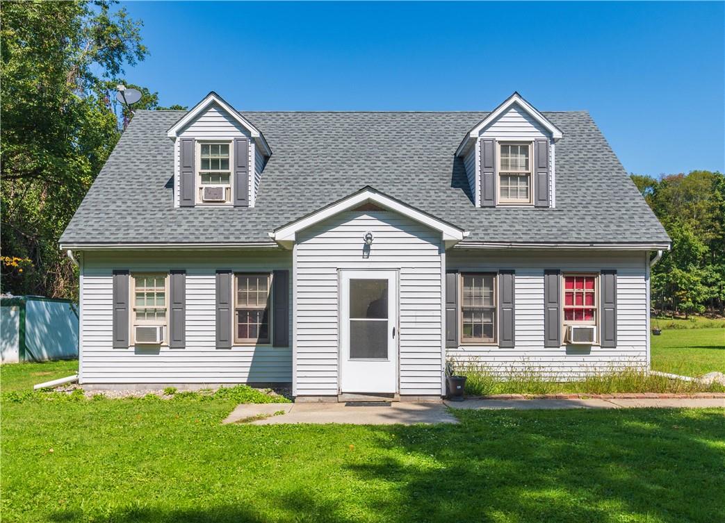 a front view of a house with a yard and porch