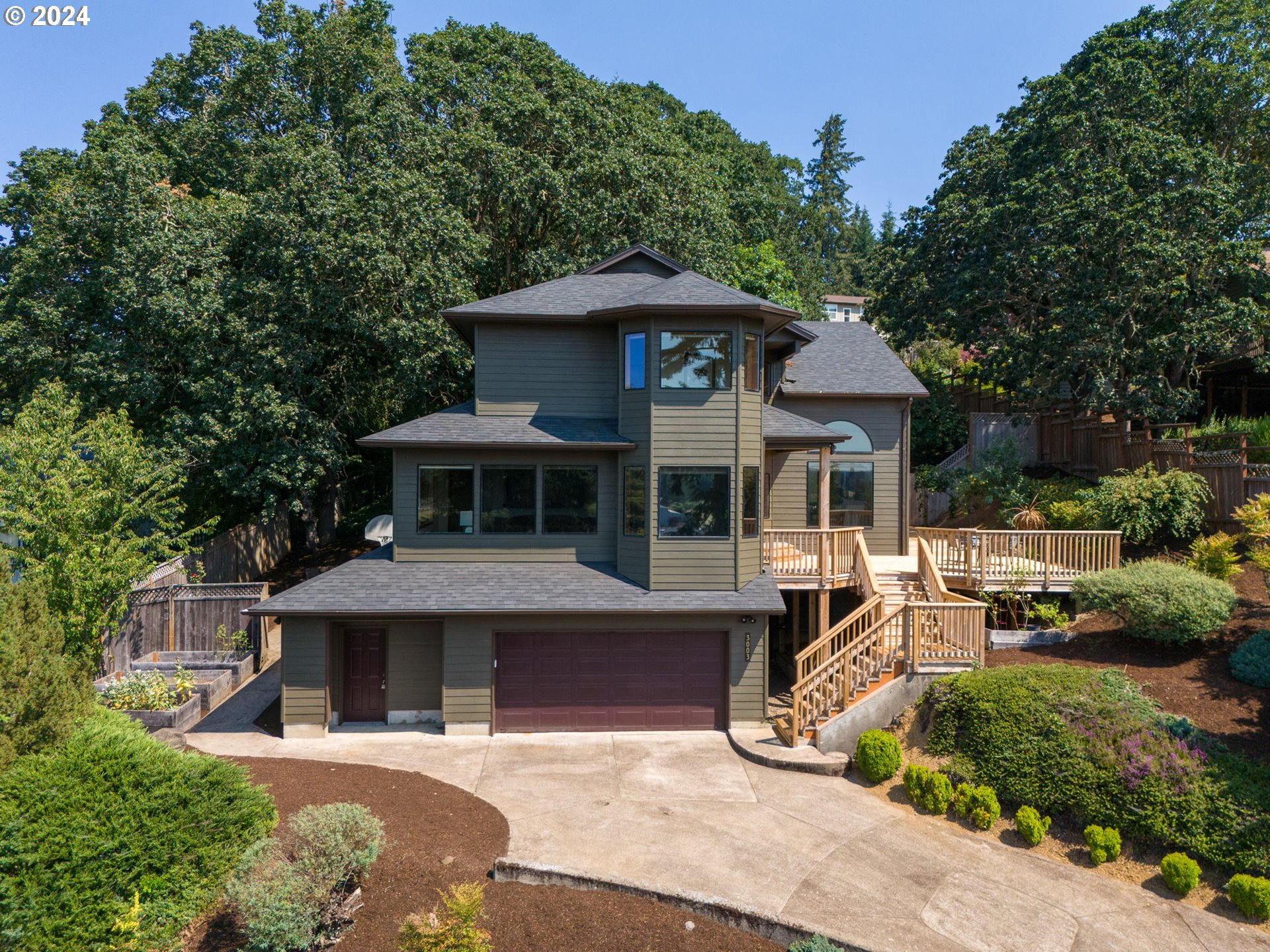 a front view of a house with yard and green space