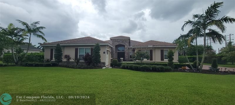 a front view of a house with a garden and patio