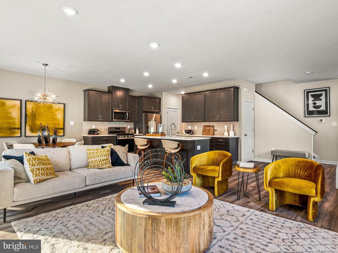 a living room with lots of furniture and kitchen view