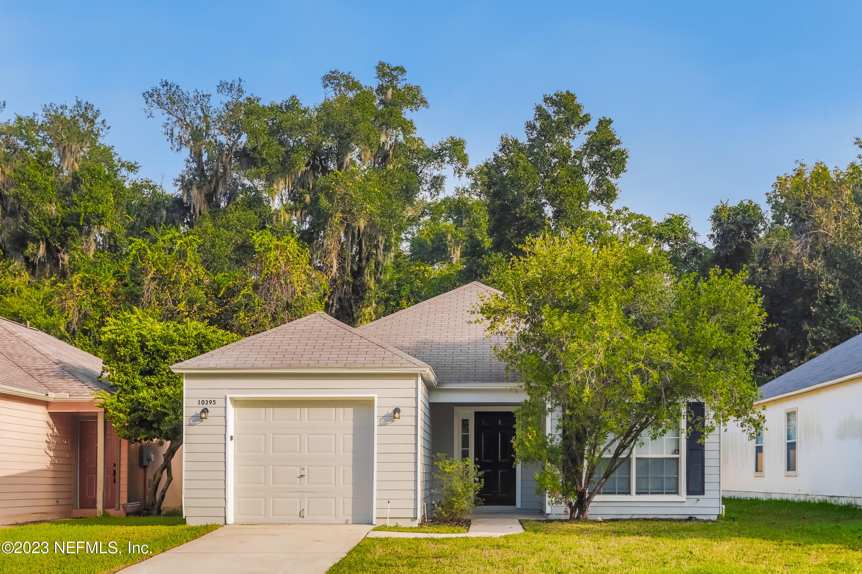 a front view of a house with a yard garage and outdoor seating