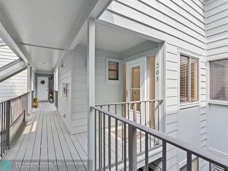 a view of a balcony with wooden floor