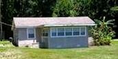 a view of house with backyard and glass door