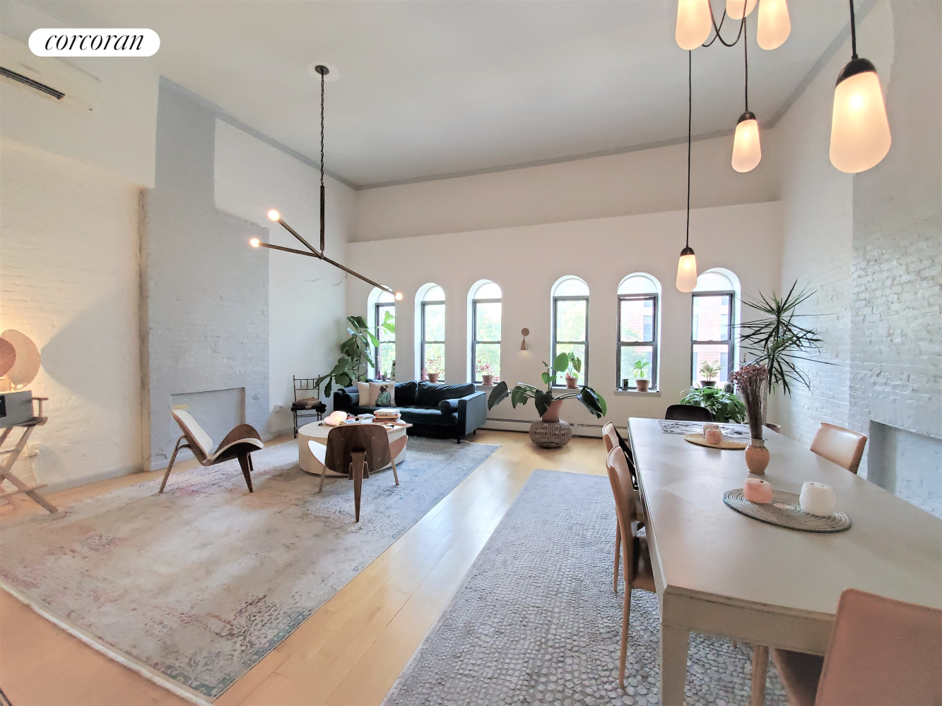 a living room with lots of furniture and a chandelier