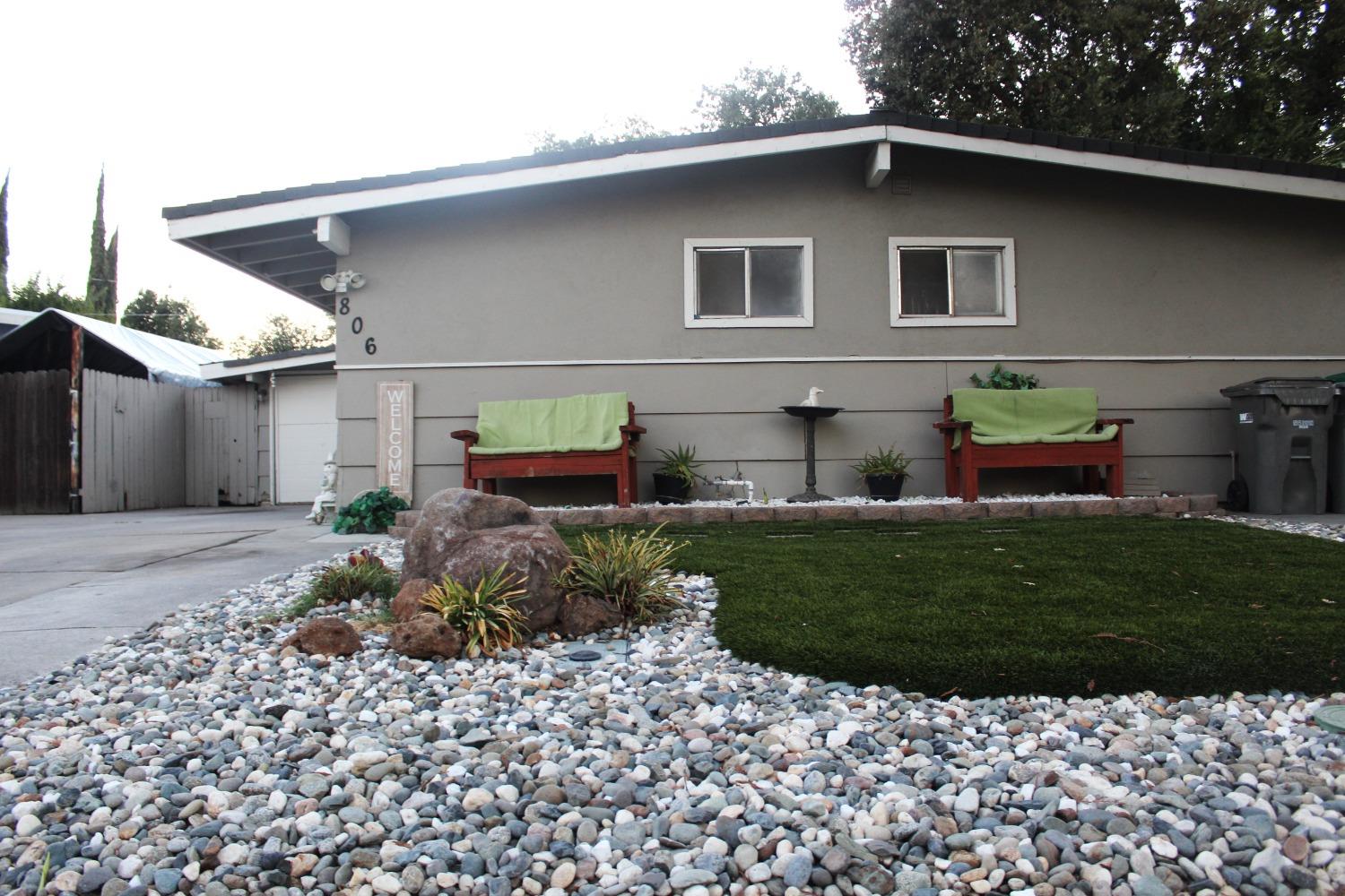 a front view of a house with a garden