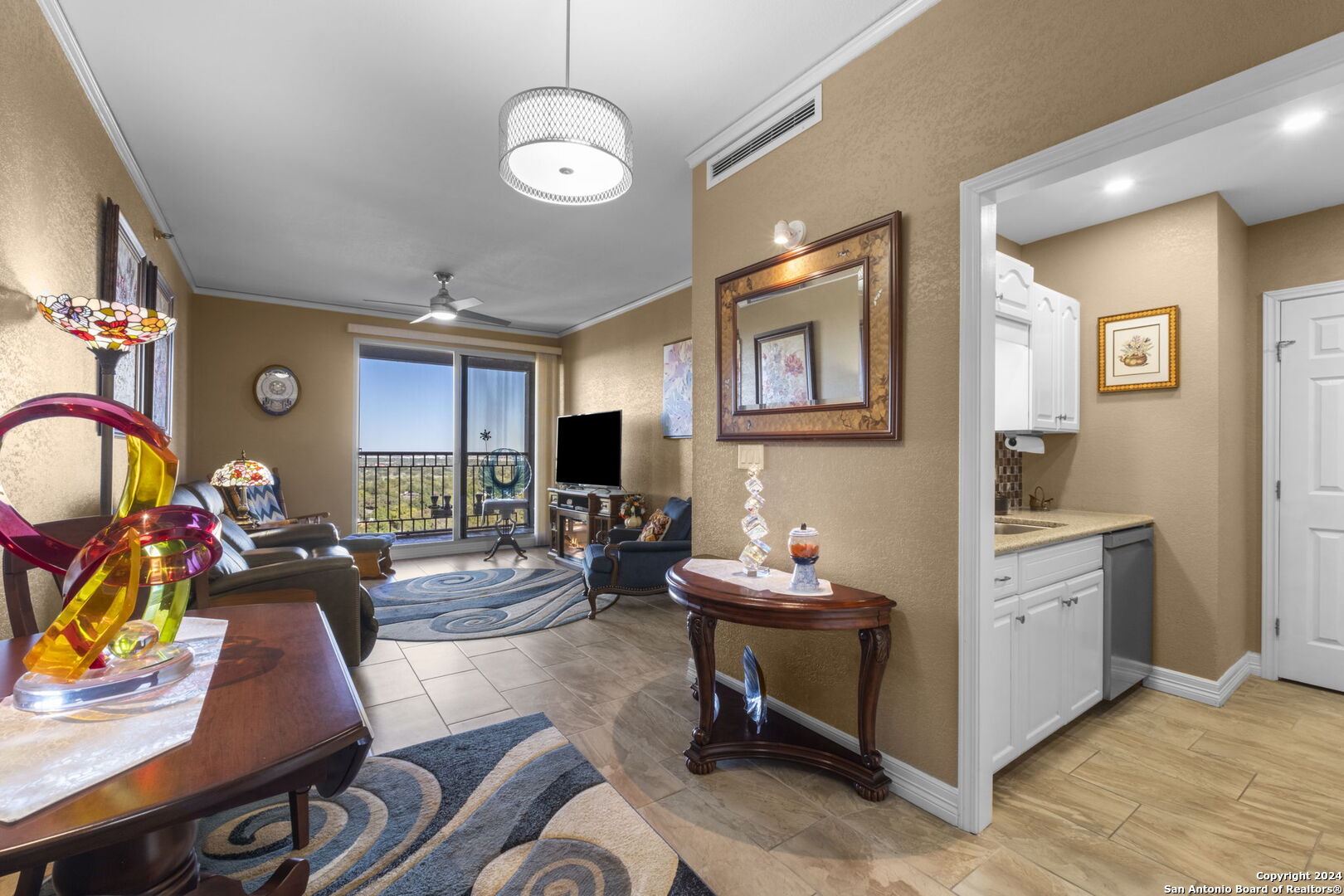 a living room with furniture a flat screen tv and a large window