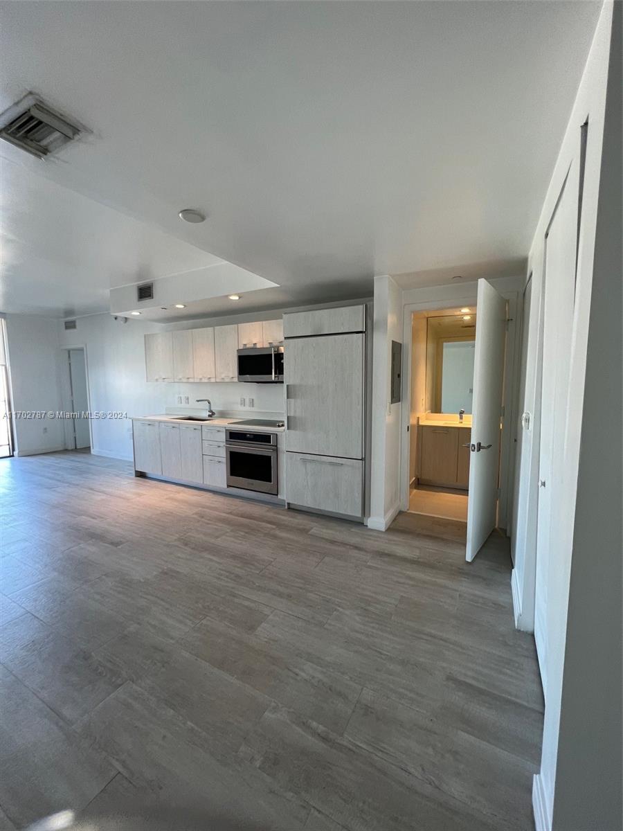 a view of kitchen with a sink and a stove top oven