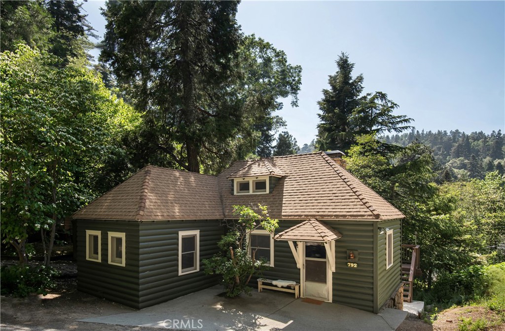 a aerial view of a house next to a yard