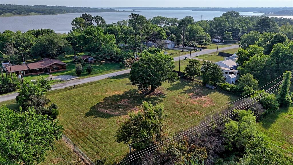 an aerial view of residential houses with outdoor space and lake view