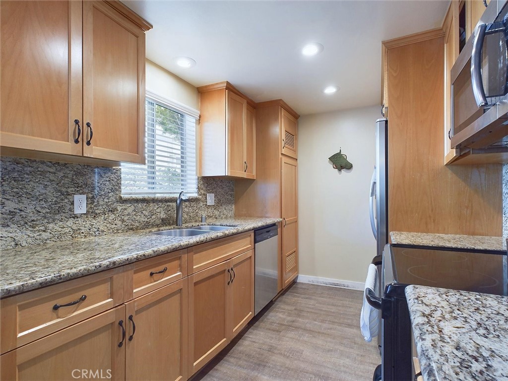 a kitchen with kitchen island granite countertop cabinets and window