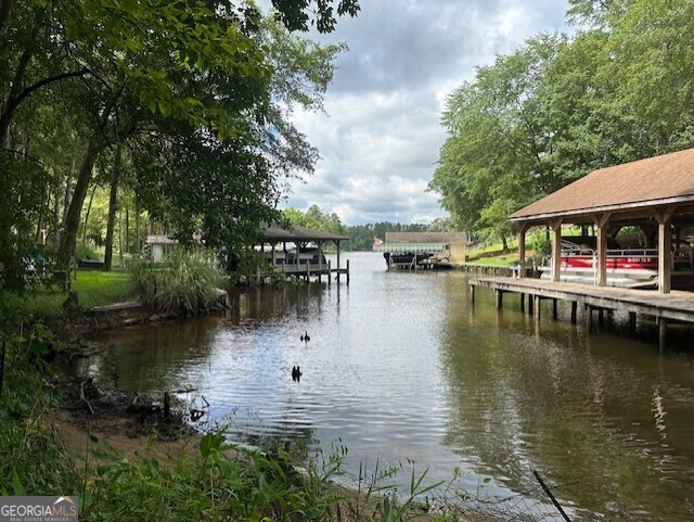 a view of swimming pool with outdoor seating and lake