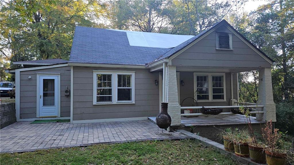 a front view of a house with garden and porch