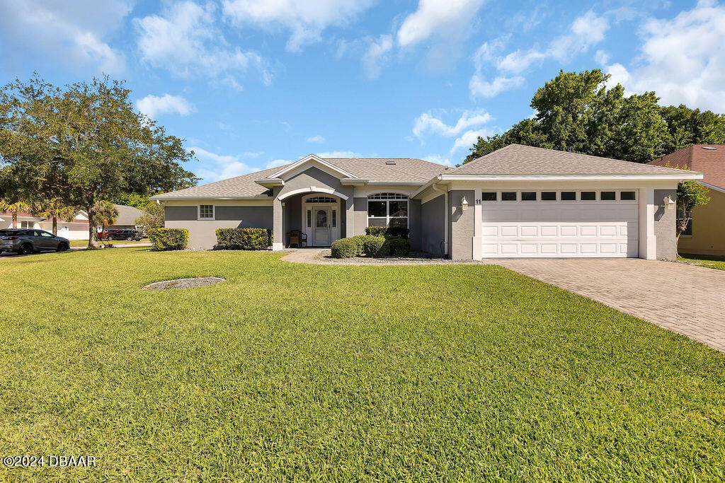 a front view of a house with a garden