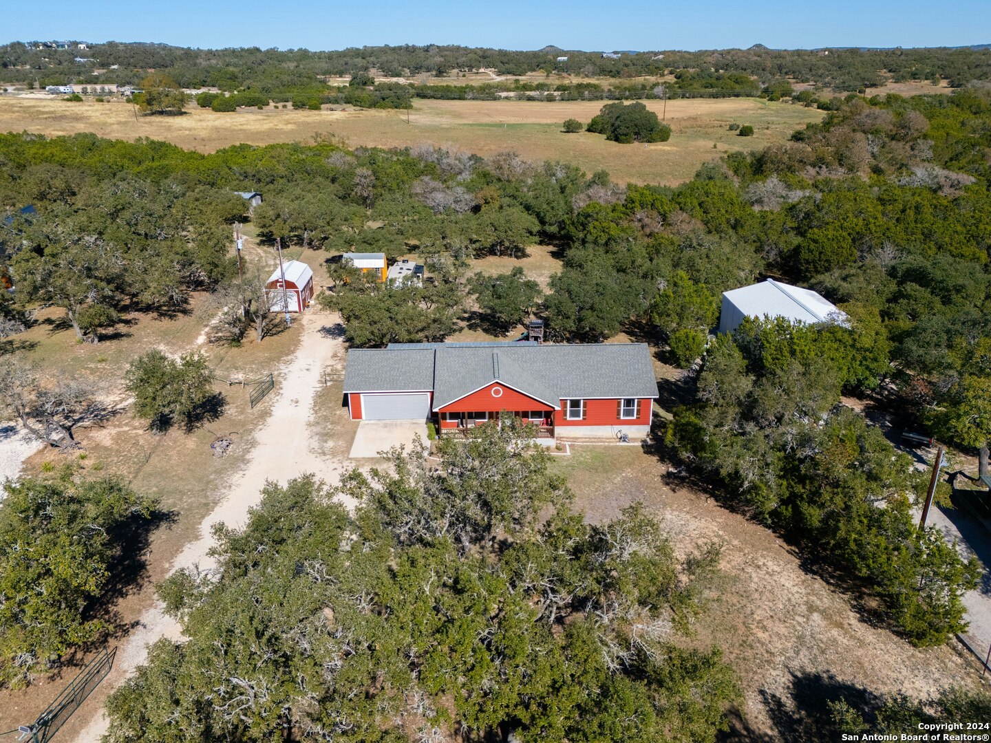 an aerial view of residential houses with outdoor space and river