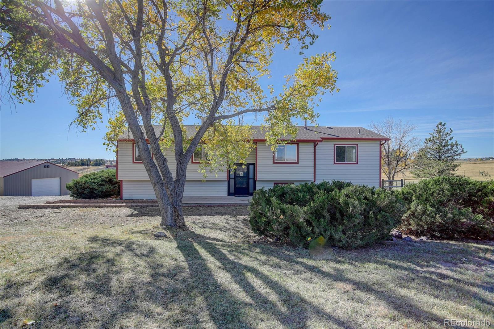 a view of a house with a tree in the background