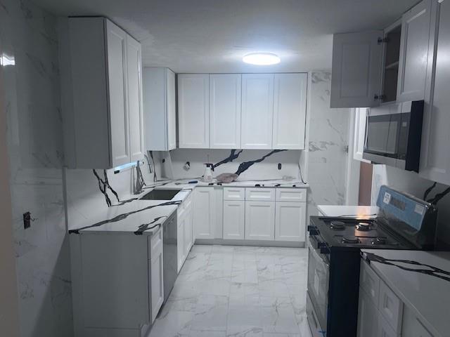 a kitchen with a sink stove and refrigerator