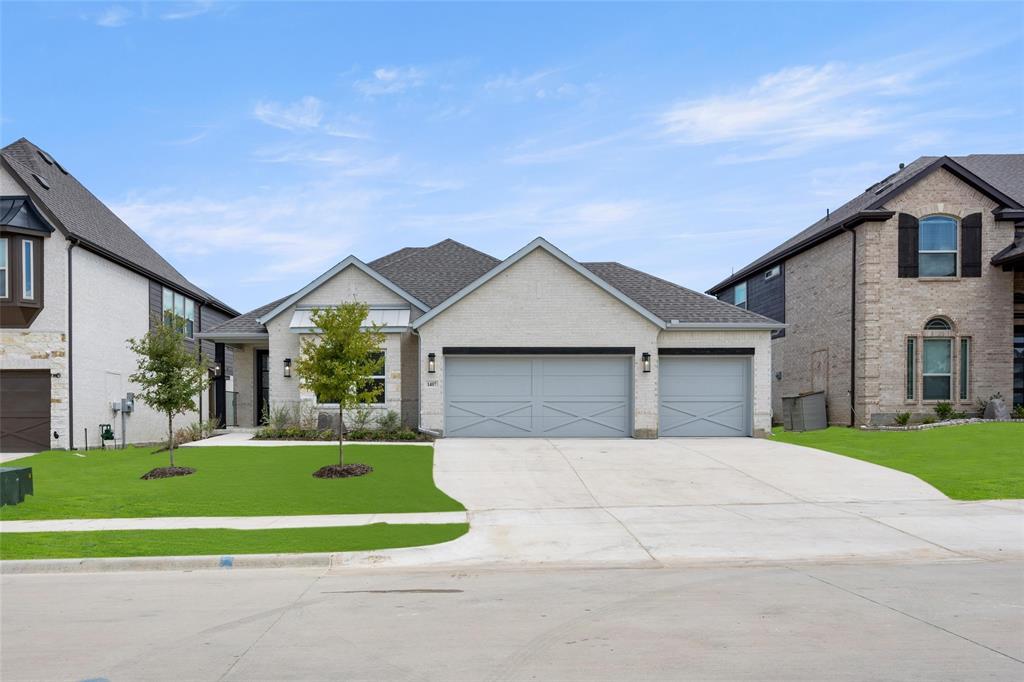 a front view of a house with a yard and trees