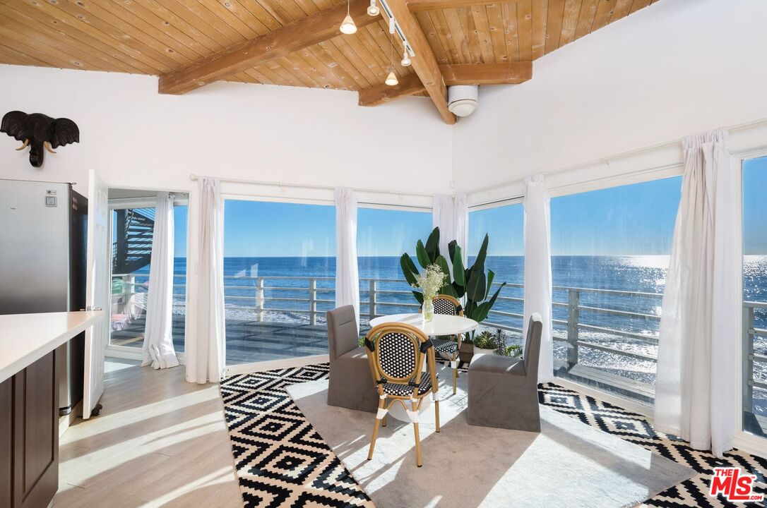 a living room with furniture a chandelier and a window