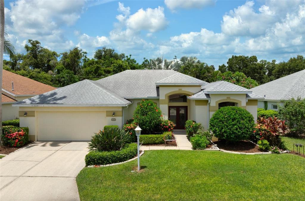 a aerial view of a house with a yard and potted plants