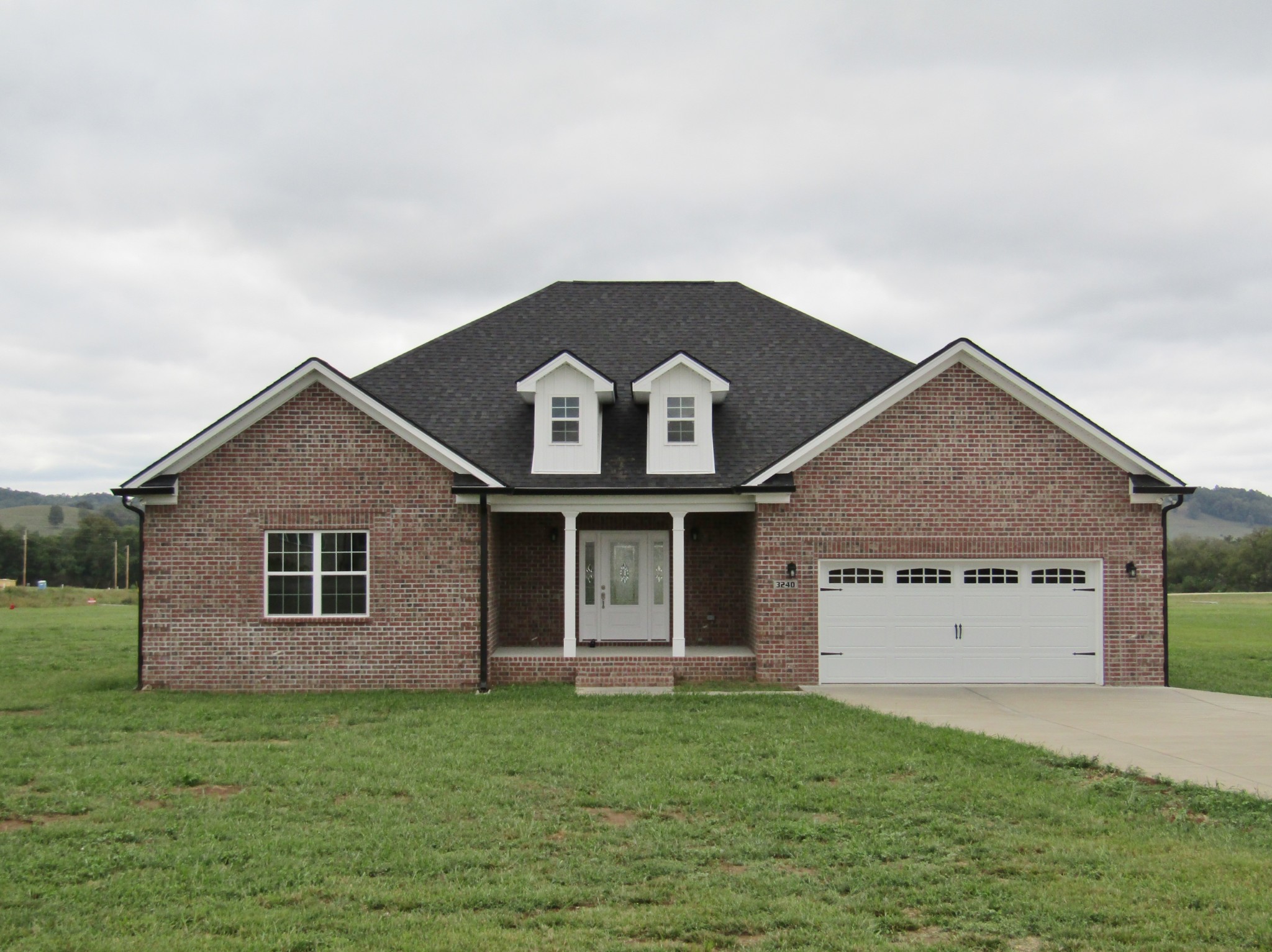 a view of a house with a yard and garage