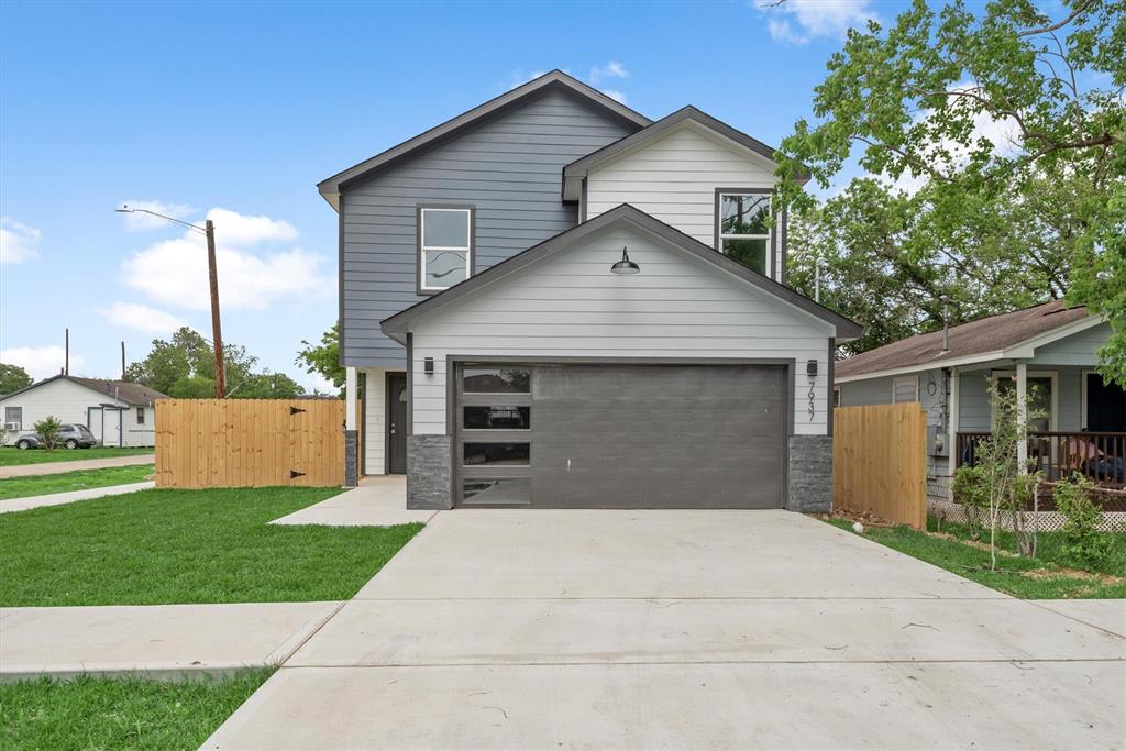 a front view of a house with a yard and garage