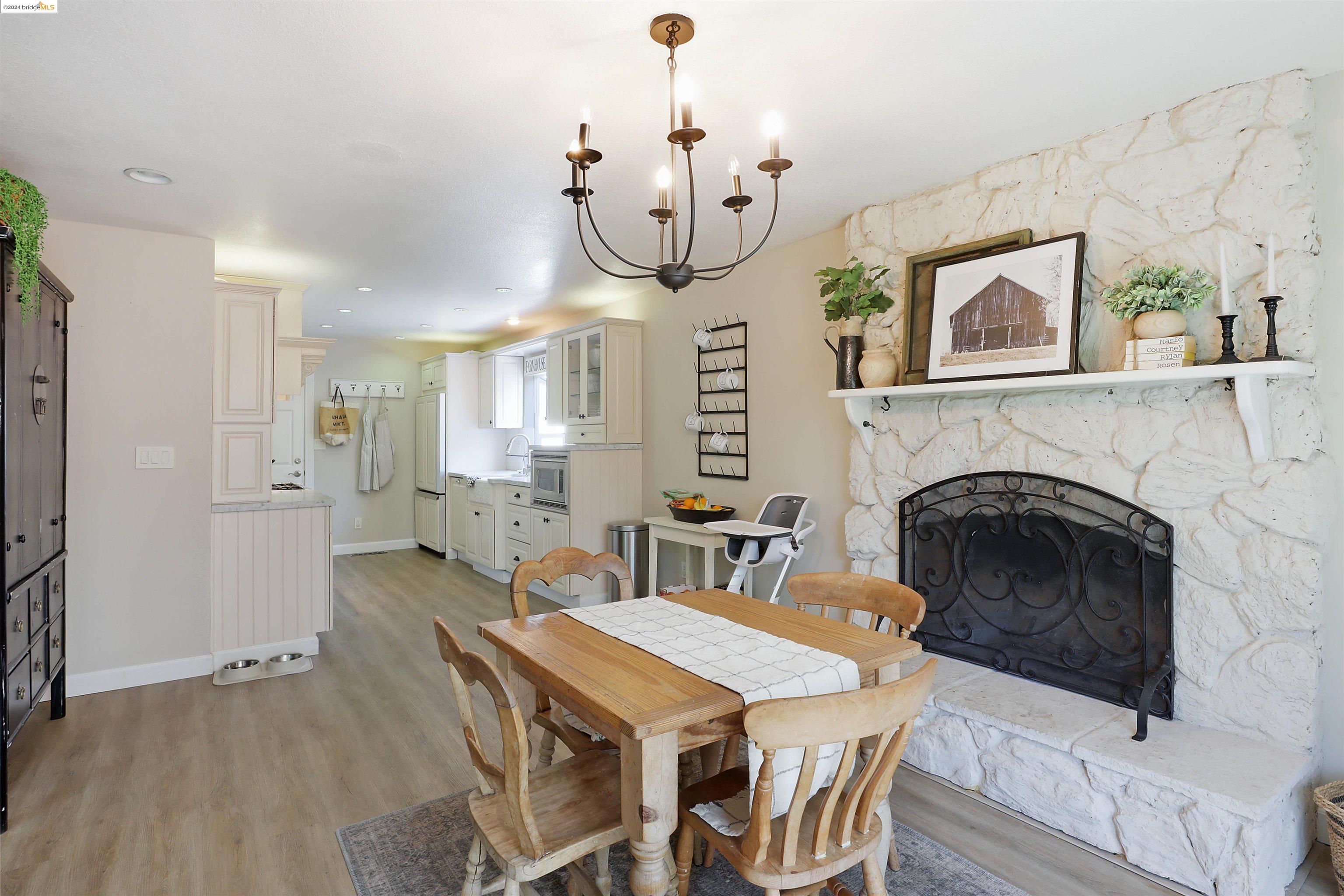 a view of a dining room with furniture wooden floor and a chandelier