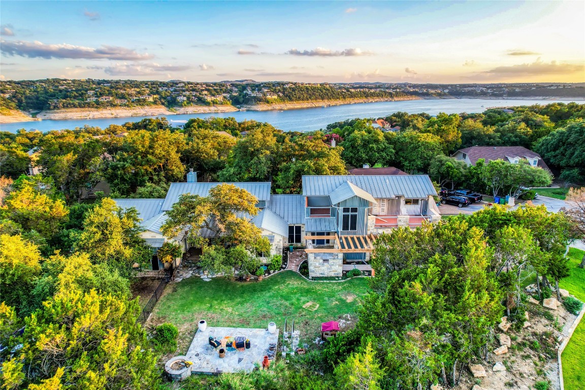 an aerial view of a house with a garden and lake view