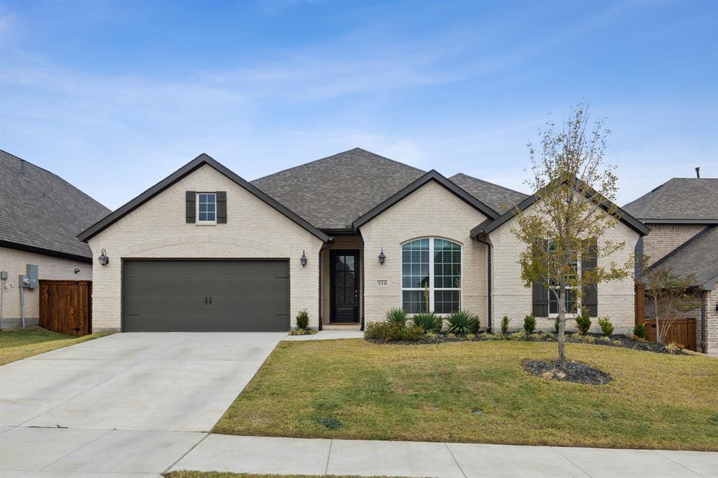 a view of a house with a yard and garage