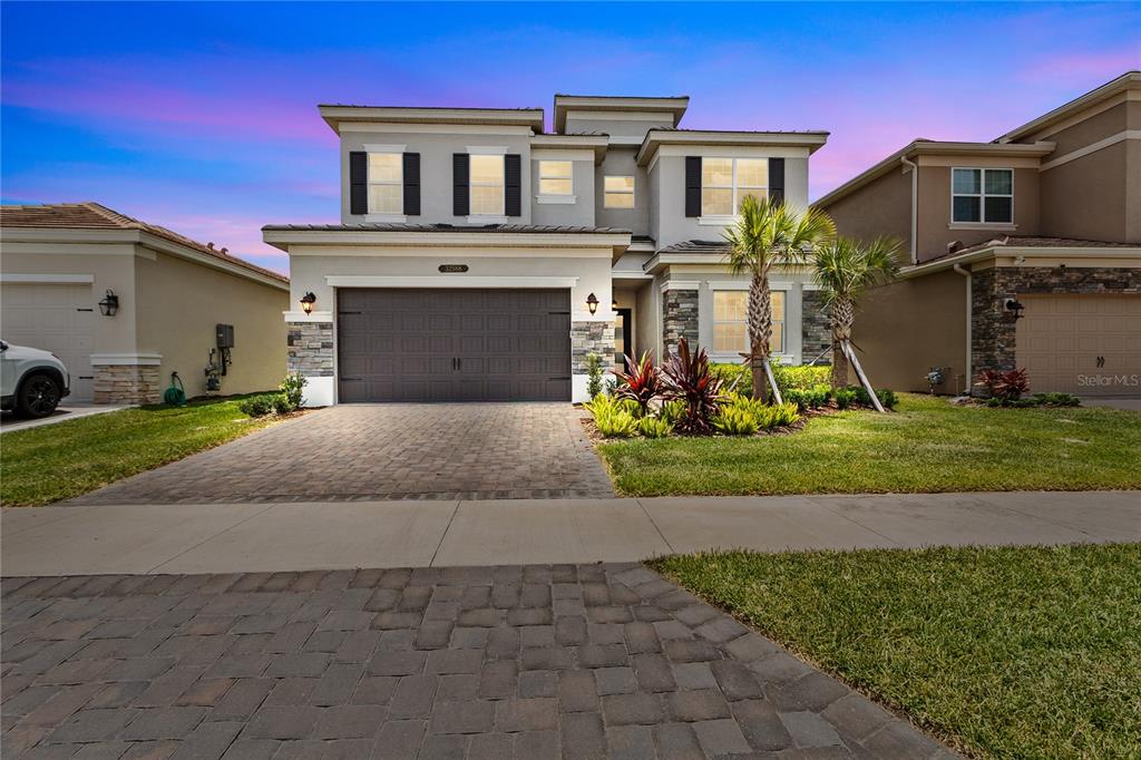 a front view of a house with a yard and garage