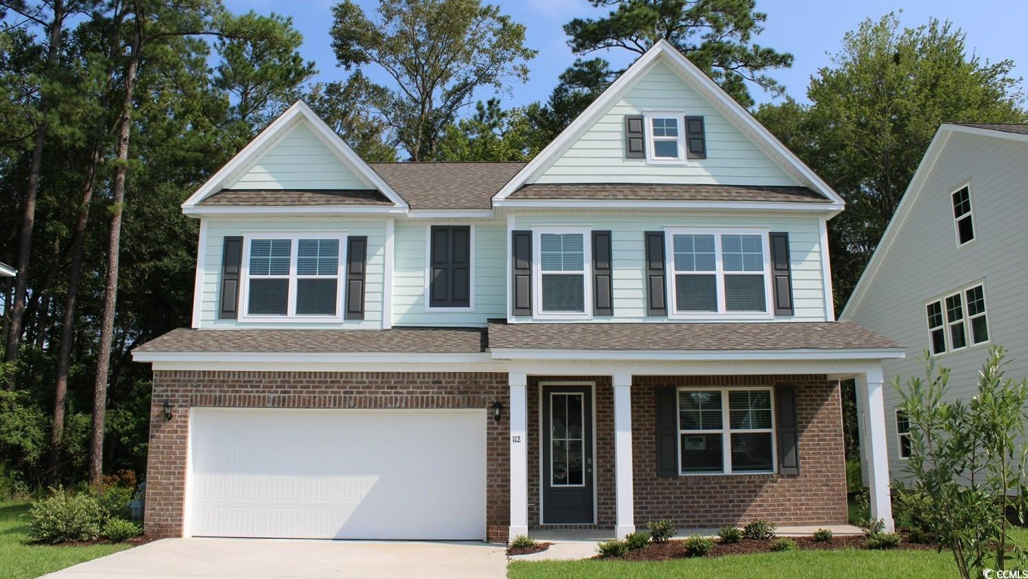 Craftsman-style house with a porch and a garage