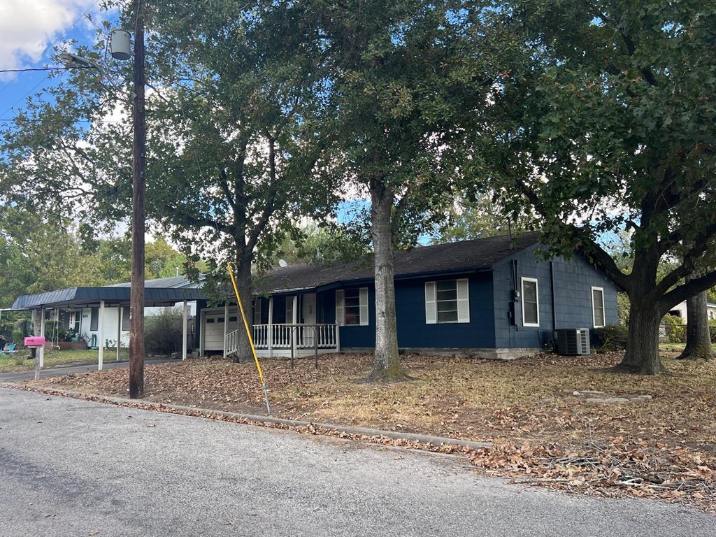 front view of a house with a tree