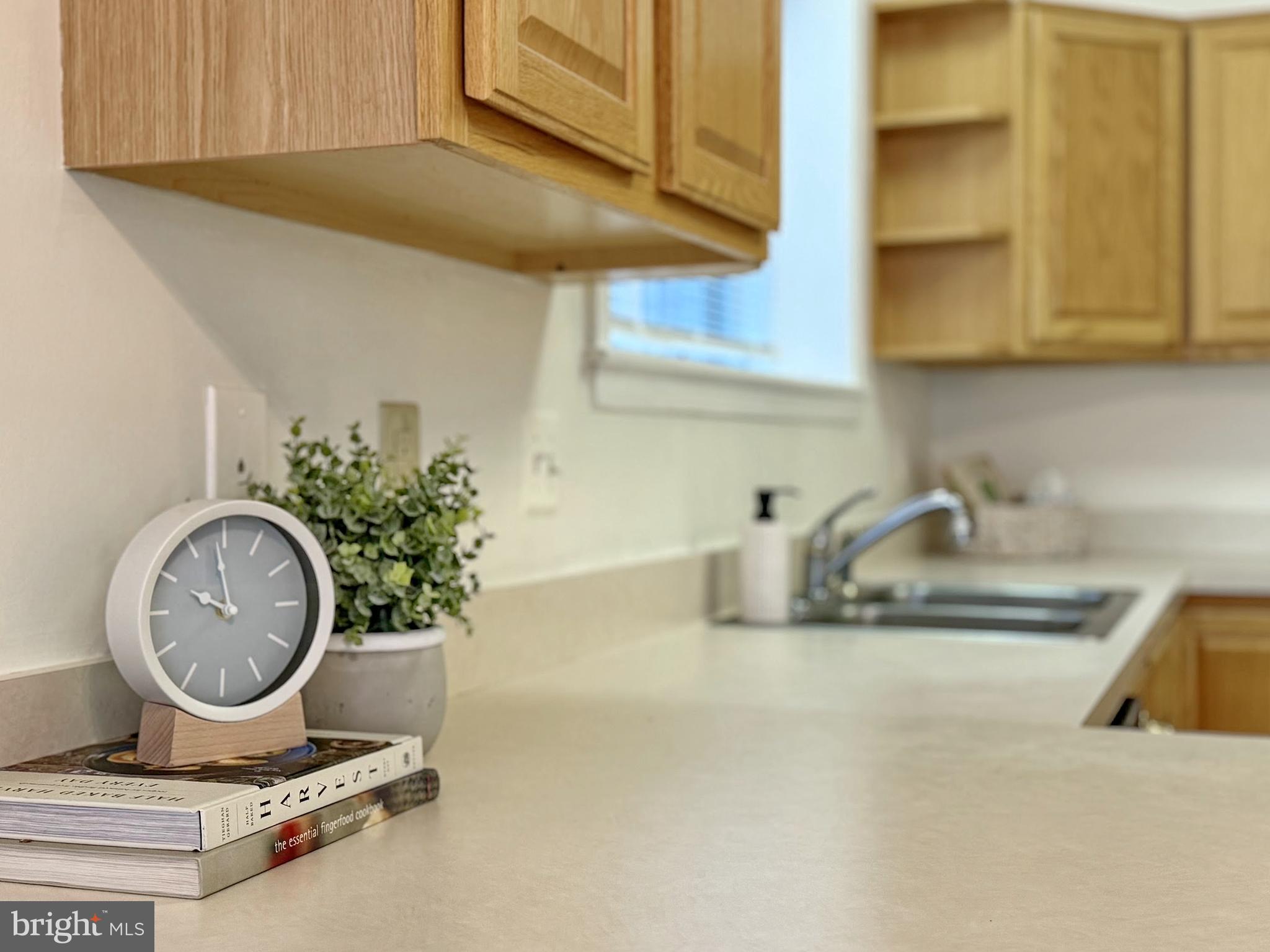 a kitchen with a sink a stove and cabinets