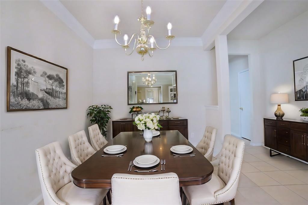 a dining room with furniture a large window and wooden floor