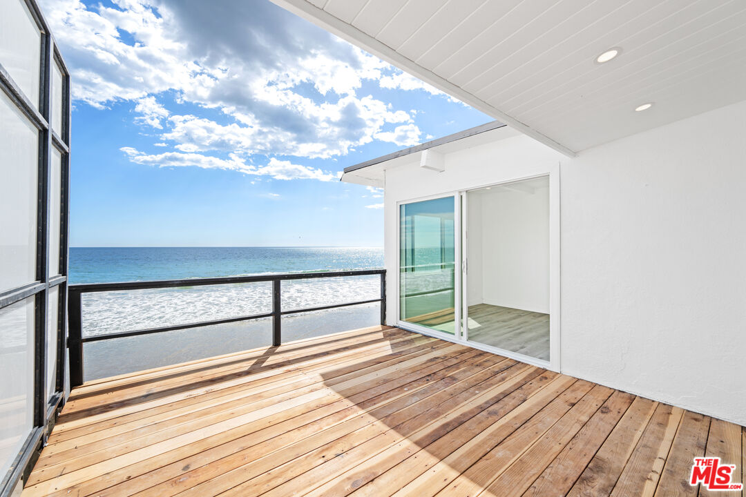 a view of a room with wooden floor and a window