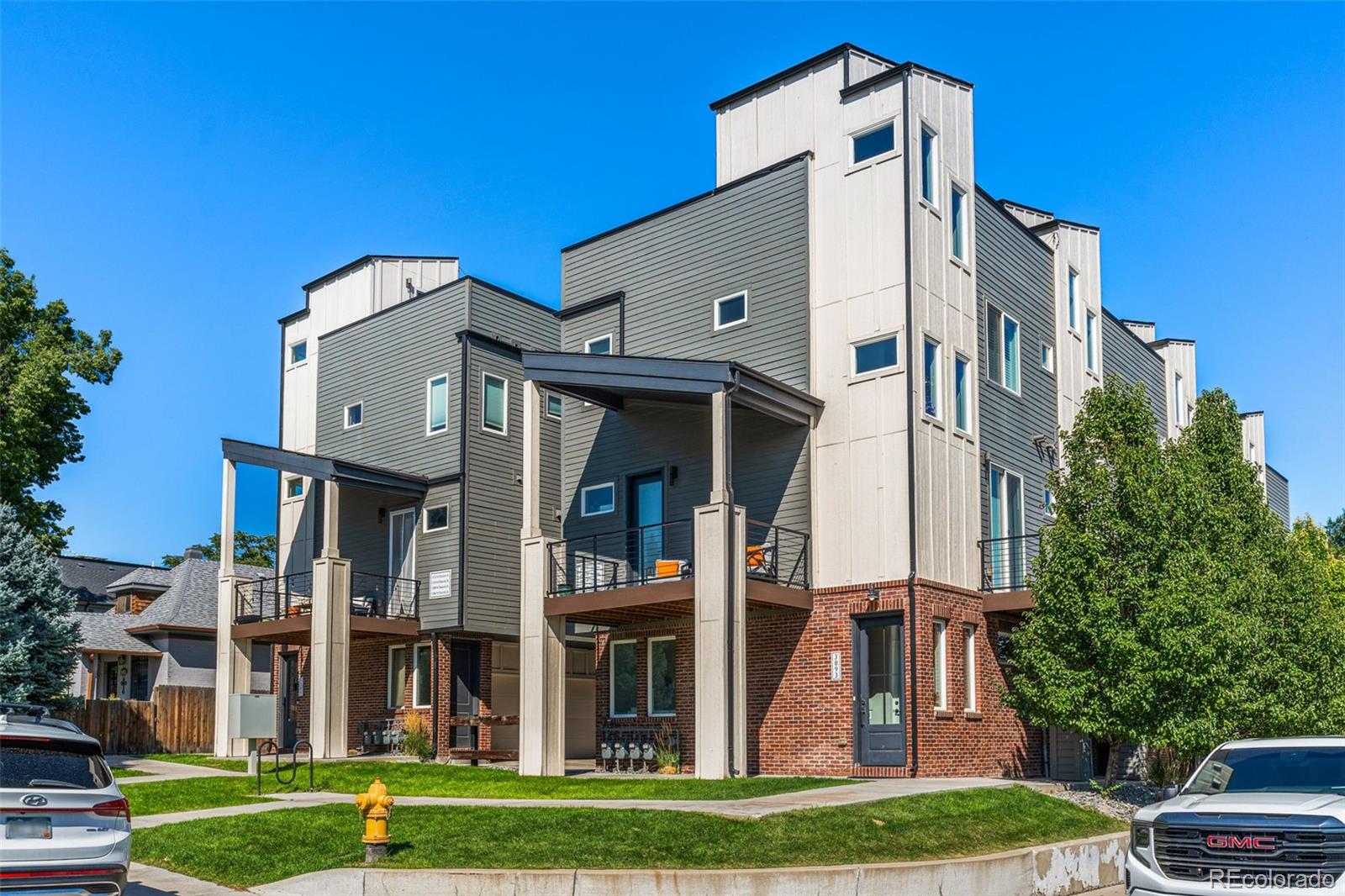 a front view of a residential apartment building with a yard